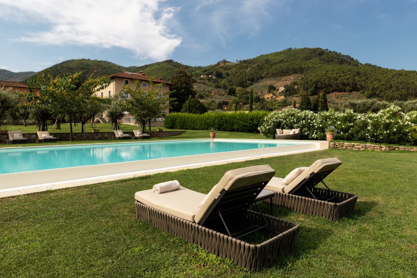The outdoor pool with sun beds